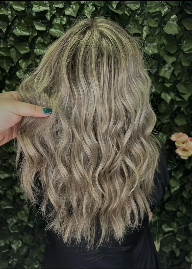 ash blonde waves with dark roots touch of teal for ponchatoula's trendy hair looks
