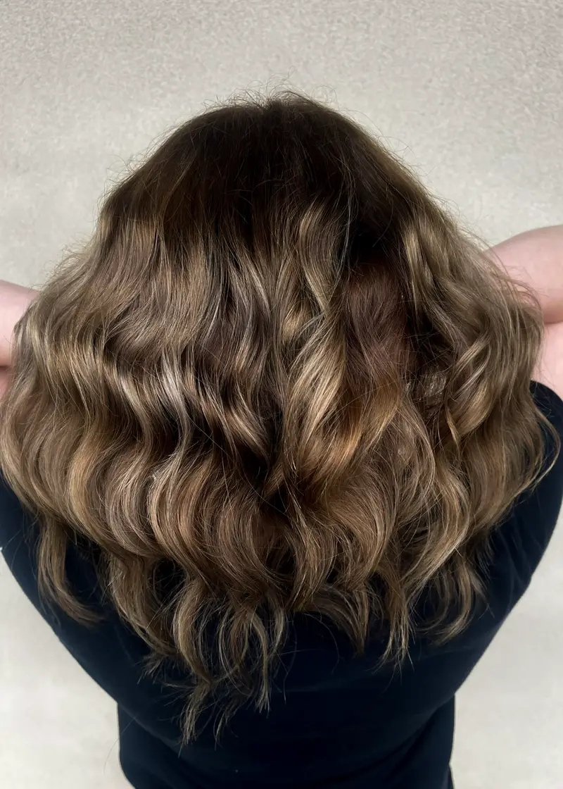 volume rich wavy brown locks with sun kissed highlights crafted in ponchatoula embrace natural elegance for your style refresh